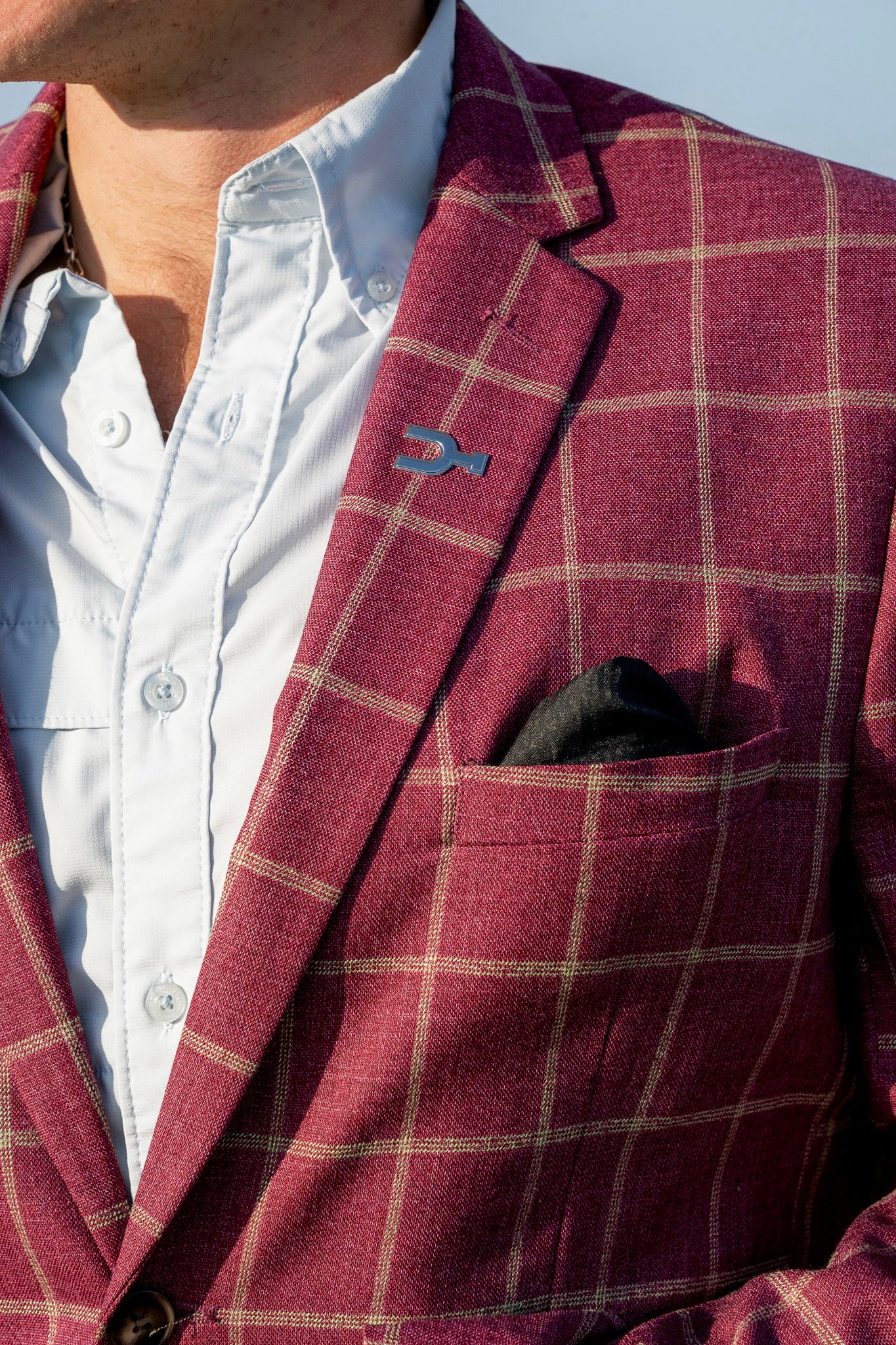 Red checkered blazer with a white shirt and black pocket square.