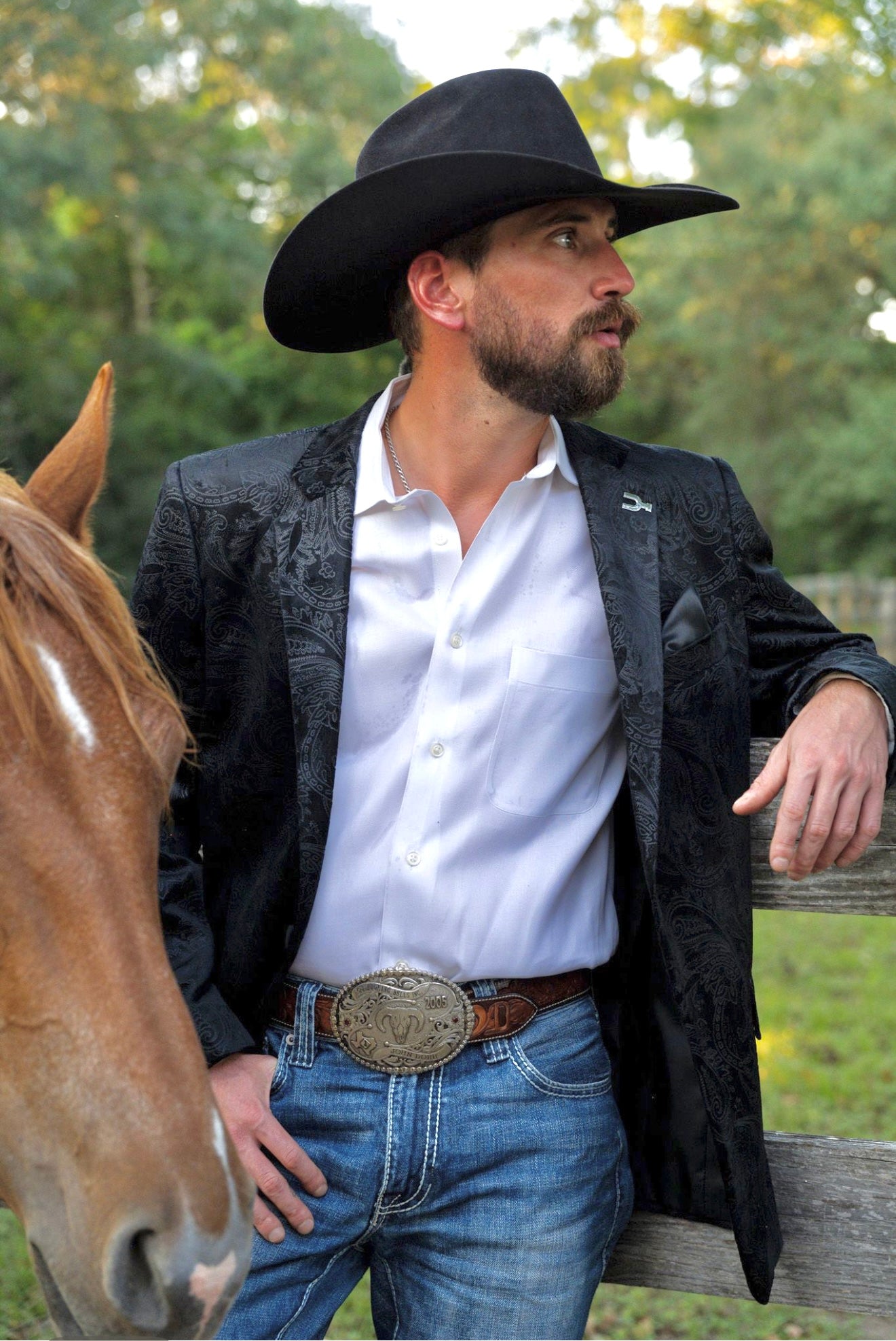 Black western formal jacket styled with boots and jeans — Espuela Design Co. classic cowboy look.