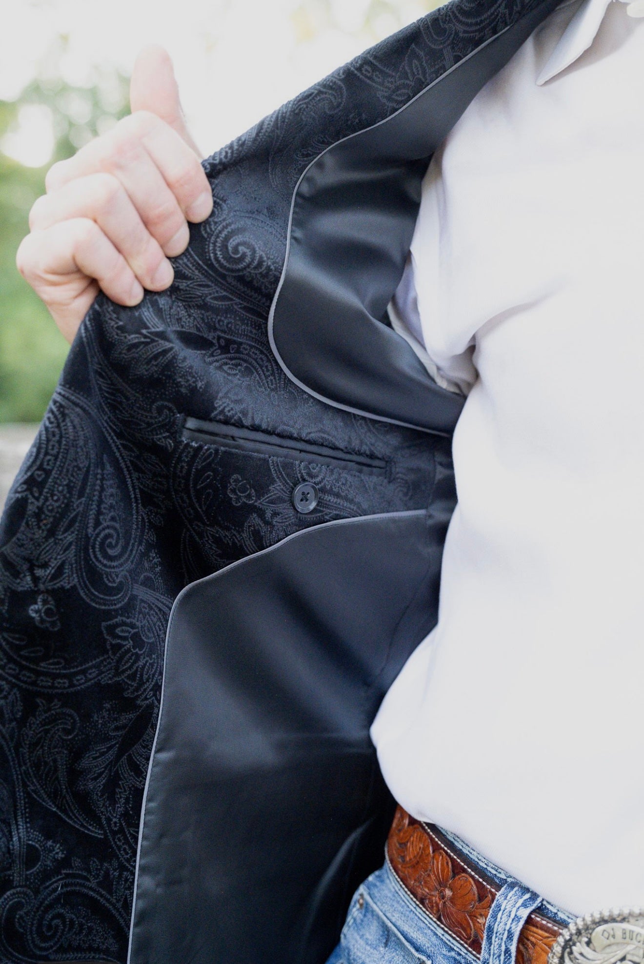 Interior lining of black western sport coat — Tetron silk craftsmanship with magnetic Espuela lapel pin.