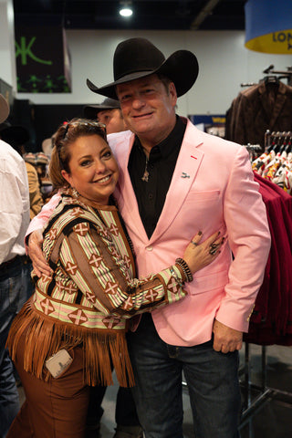Man wearing pink cowboy sport coat and black cowboy hat at western trade show event with Espuela Design Co western fashion and cowboy formalwear styling